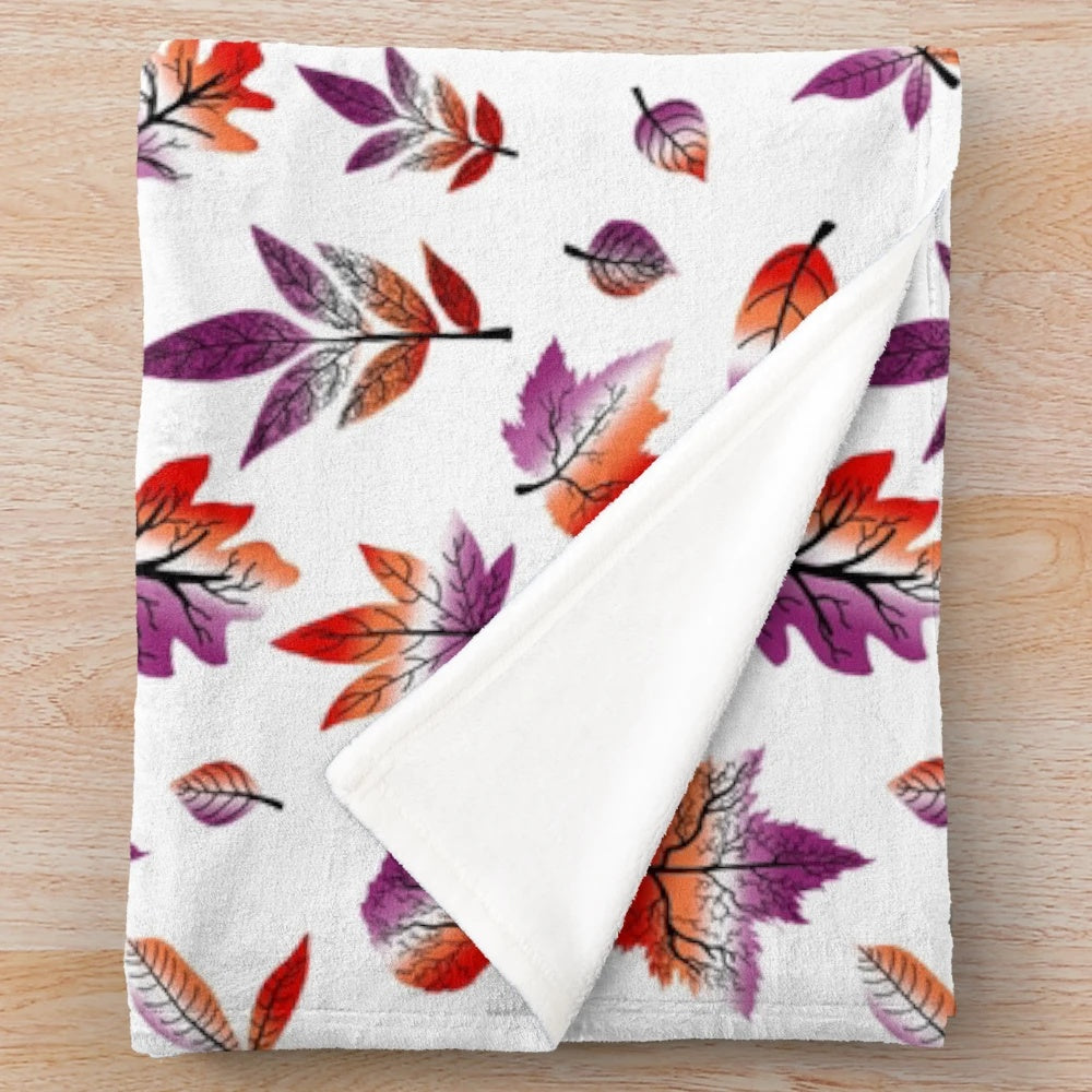 Plush blanket featuring fall leaves in pastel purple, pink, and orange colors representing the lesbian pride flag