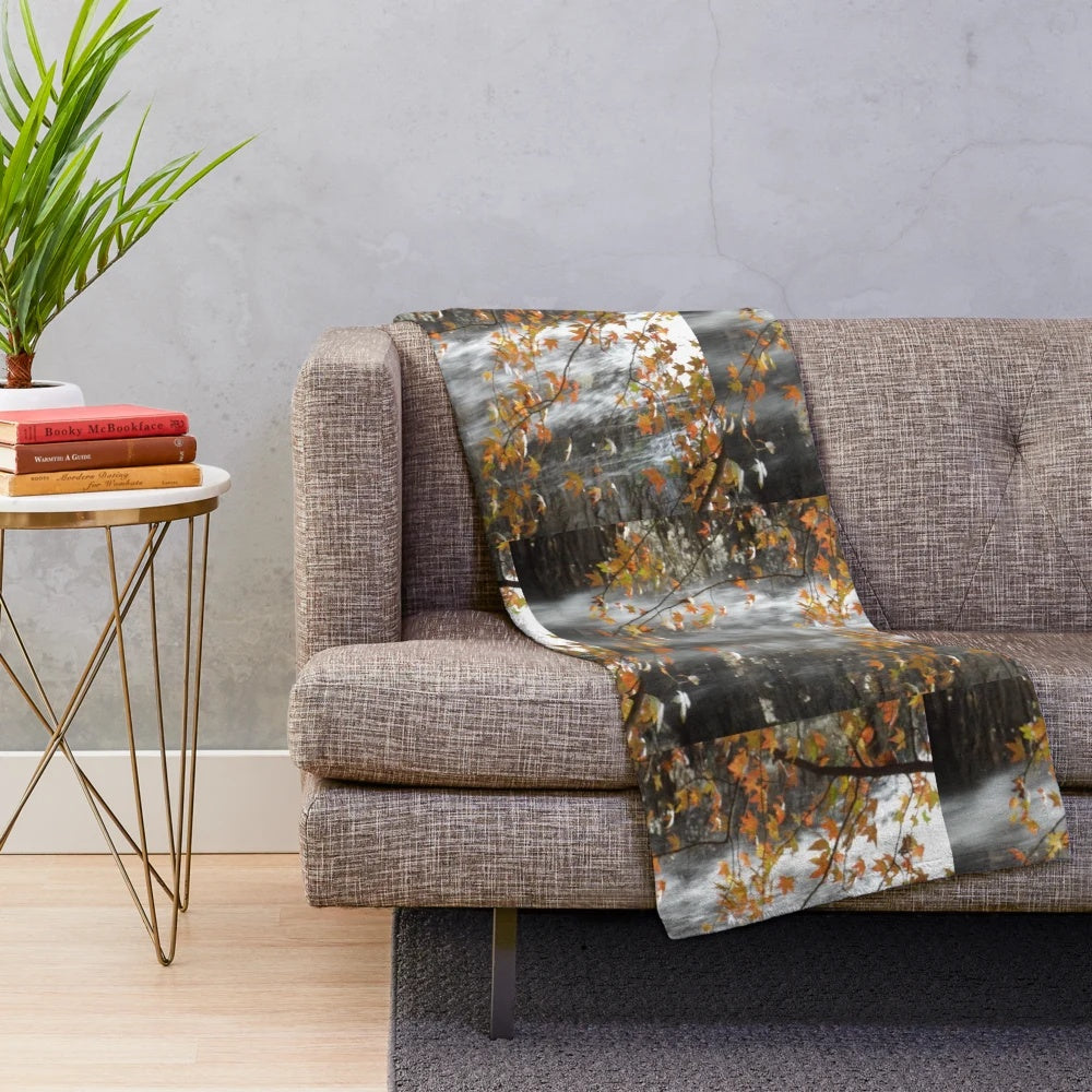 Plush blanket with fall leaves and waterfall design