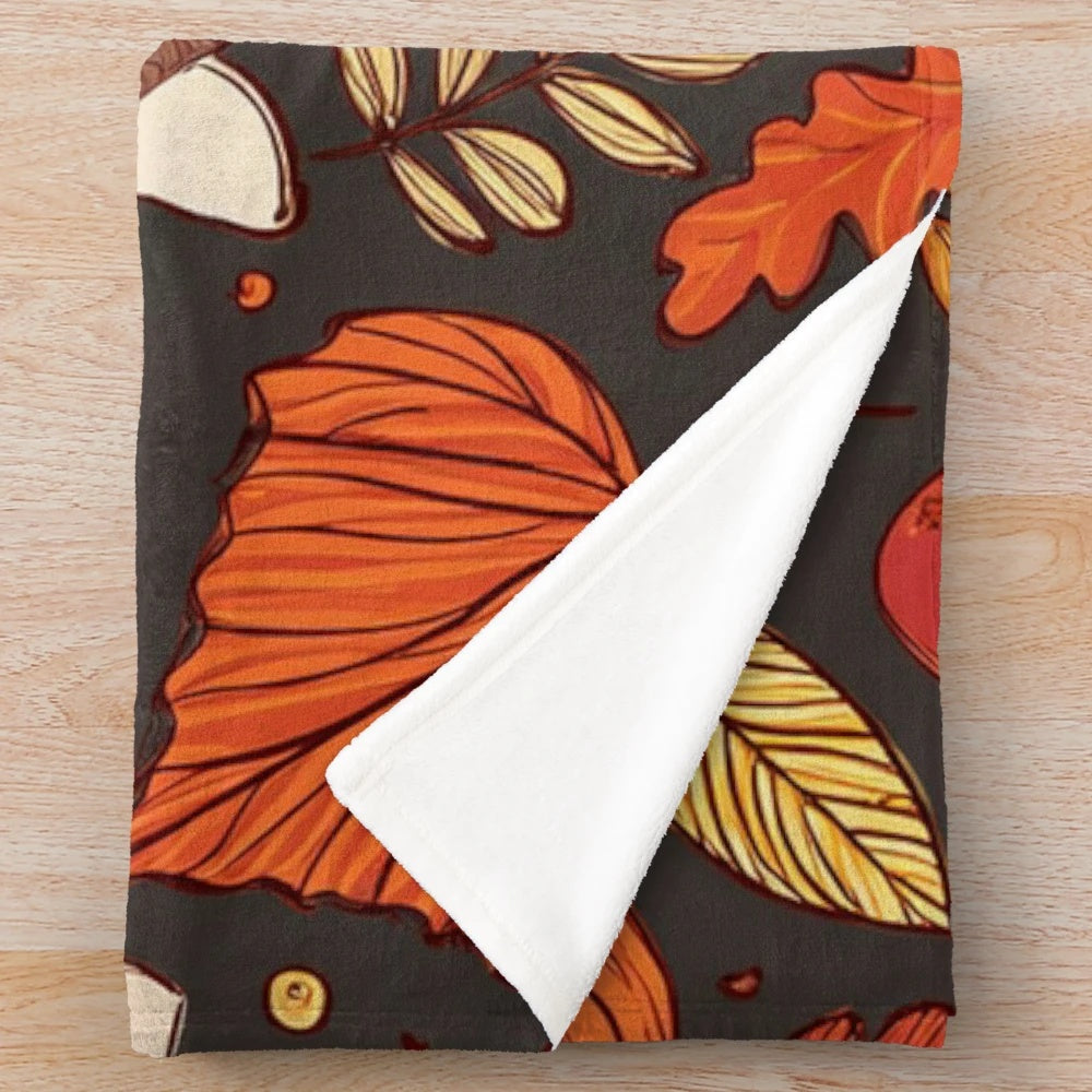 Cozy fall pattern plush blanket with leaves, mushrooms, and acorns design