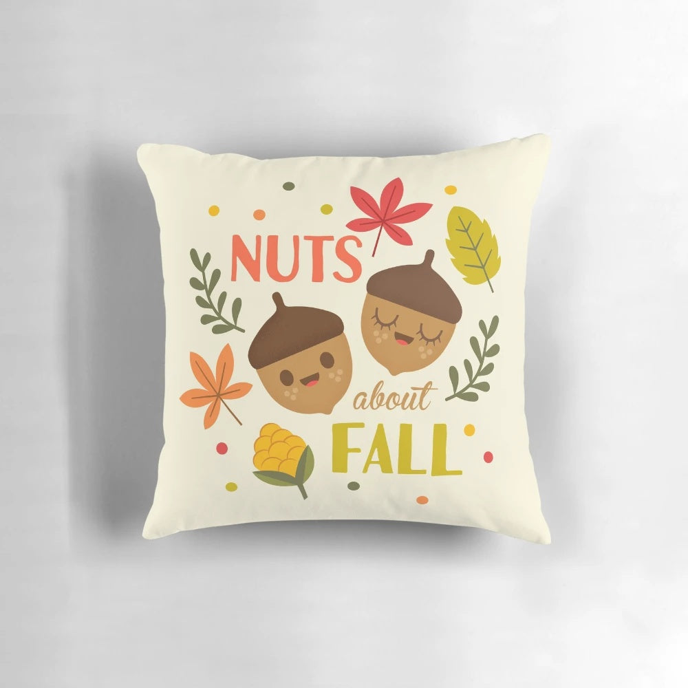 Decorative fall pillow with a charming acorn and leaf design, perfect for seasonal home accents.