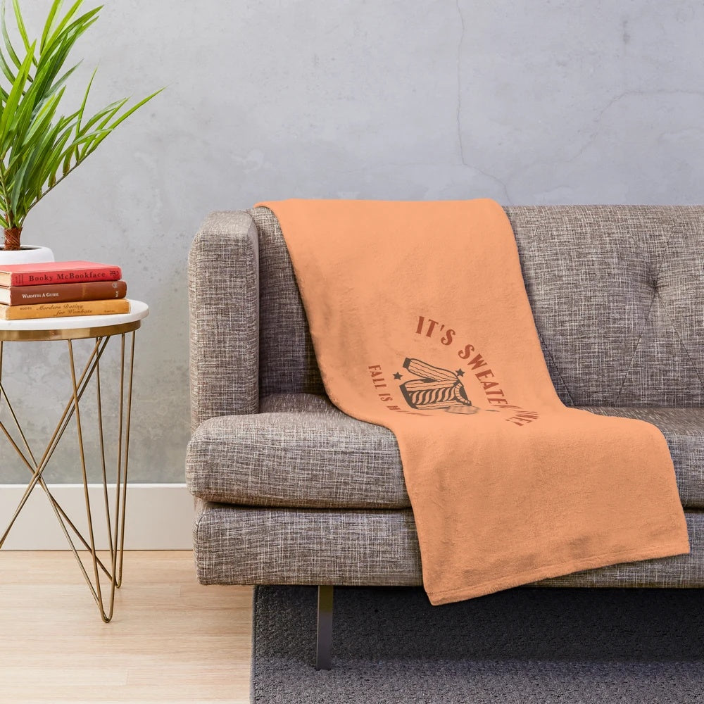 Cozy fall plush blanket with warm autumn colors and a pumpkin spice-inspired design