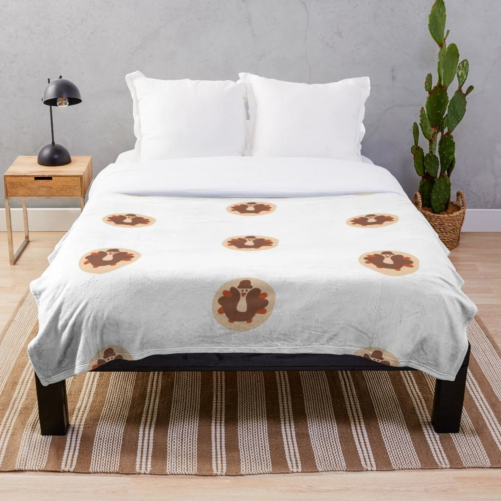 Plush blanket with fall-themed turkey cookie design