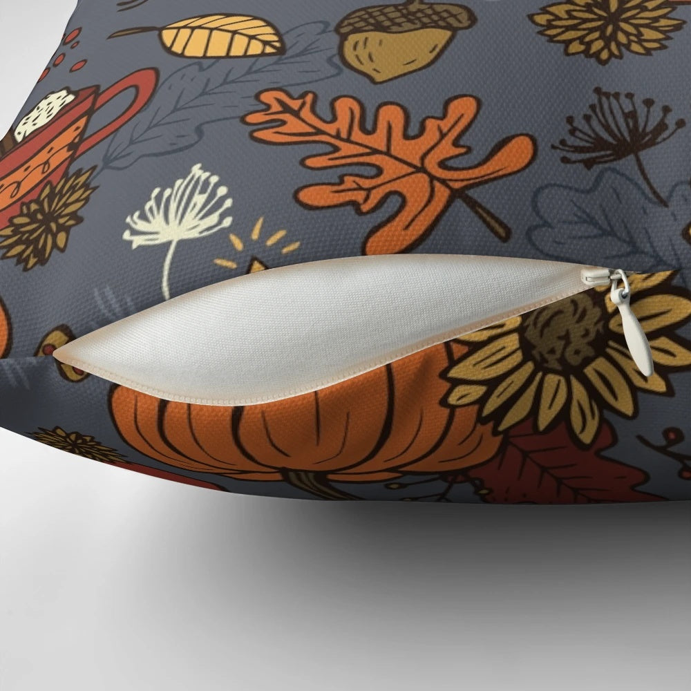 Cozy fall-inspired pattern pillow featuring pumpkins, leaves, and other autumnal elements