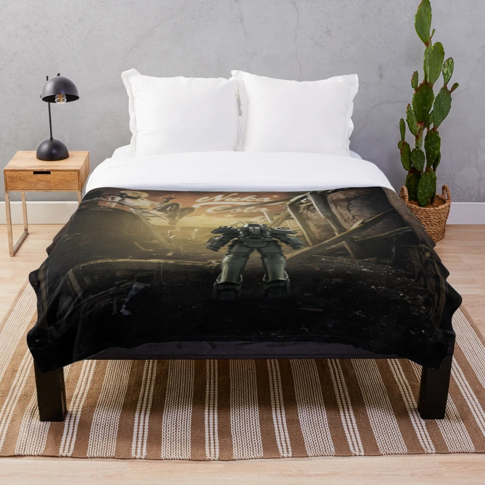 A plush blanket featuring Fallout-inspired design elements like Nuka Cola and Vault Tech logos