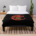 A plush red dragon-themed blanket with the text "Dragons don't believe in you