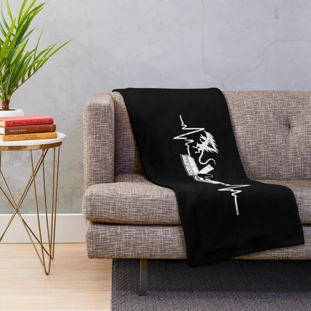 Mythical dragon themed plush blanket with a person reading a fantasy book