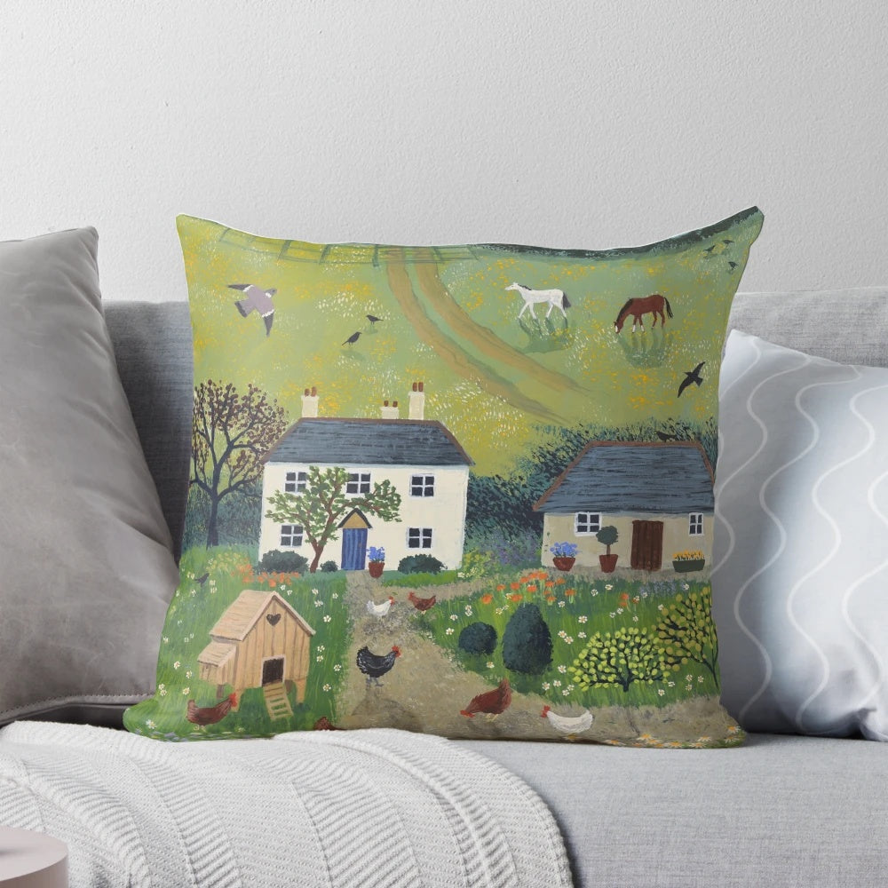 A decorative pillow featuring a charming country scene with chickens, horses, and a white cottage surrounded by a rural landscape.