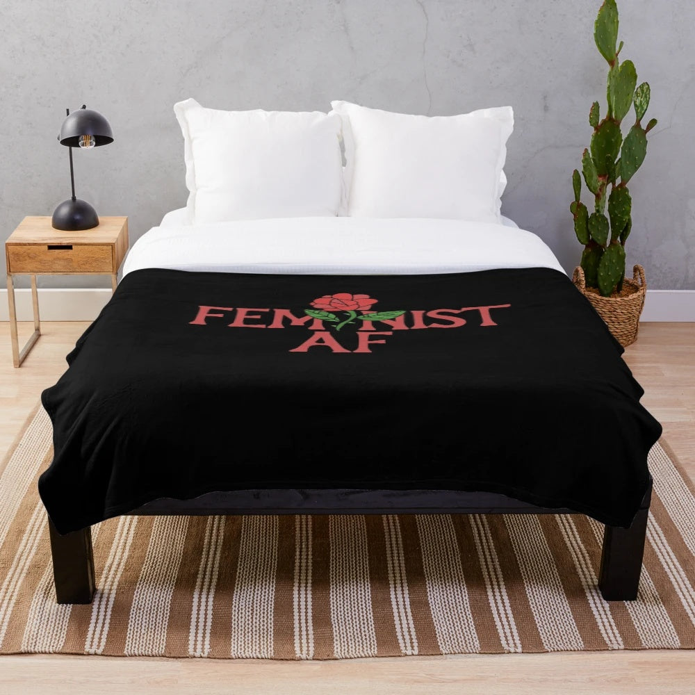Feminist-themed plush blanket with rose pattern design