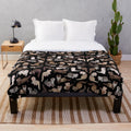 Soft and cuddly plush blanket featuring a dark sable ferret design