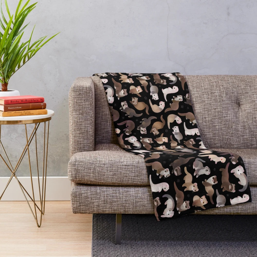 Soft and cuddly plush blanket featuring a dark sable ferret design