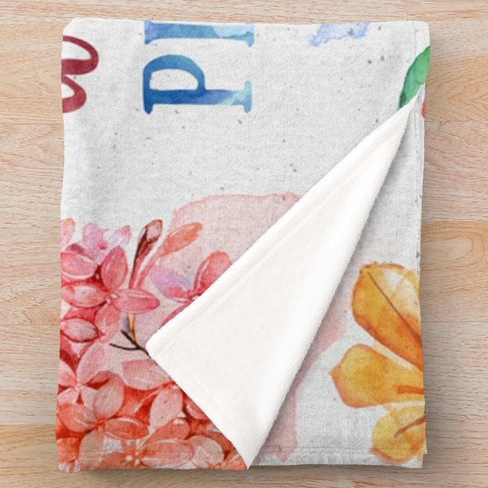 Vibrant watercolor floral pattern plush blanket for cozy reading and relaxation