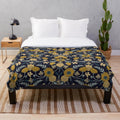 Navy blue, turquoise, cream and mustard yellow floral patterned plush blanket