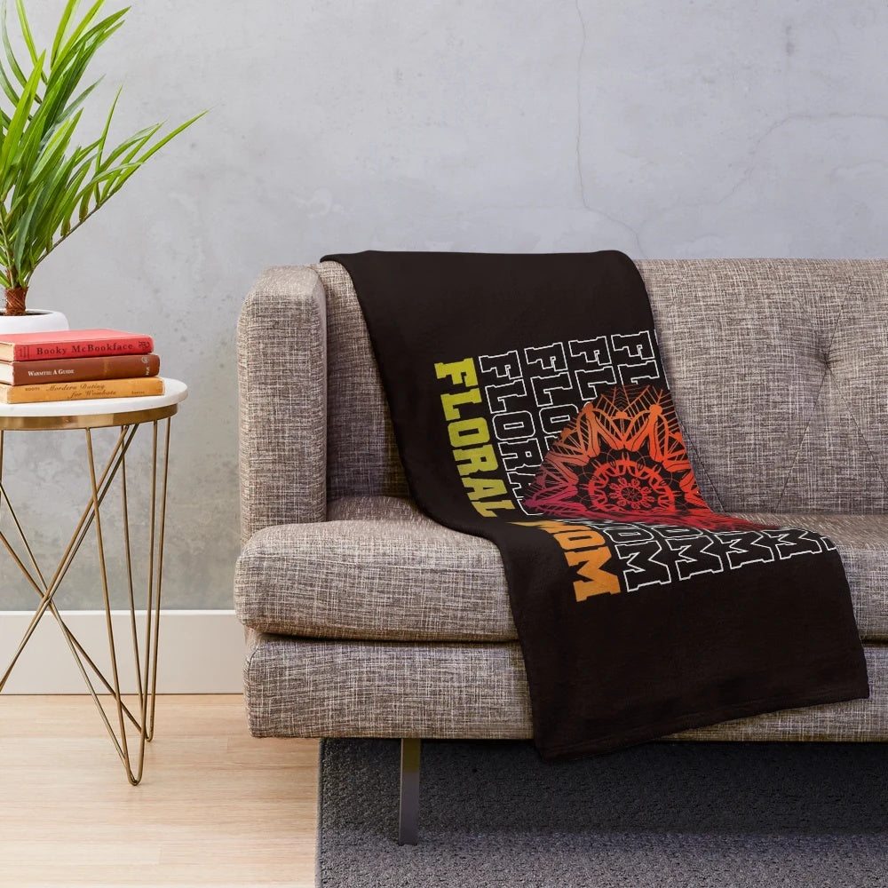 A soft and plush floral-patterned blanket featuring a heartwarming mom quote