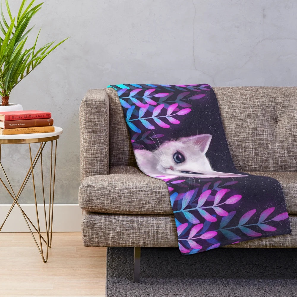 Plush blanket with a foliage design and celestial accents