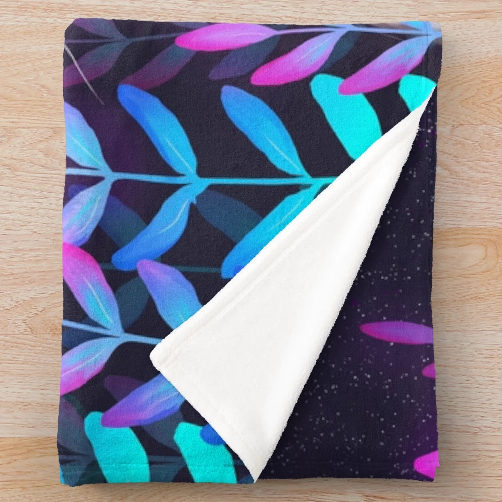 Plush blanket with a foliage design and celestial accents