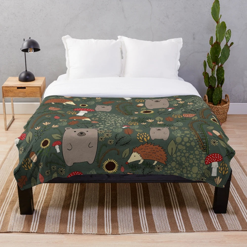 Soft and warm plush blanket featuring adorable forest animals like bears and hedgehogs in an autumn woodland setting