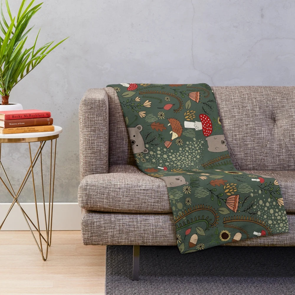 Soft and warm plush blanket featuring adorable forest animals like bears and hedgehogs in an autumn woodland setting