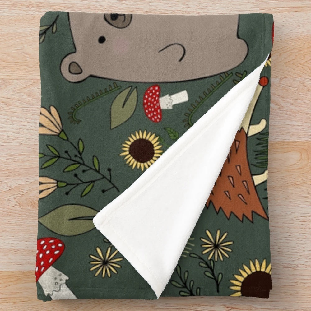 Soft and warm plush blanket featuring adorable forest animals like bears and hedgehogs in an autumn woodland setting