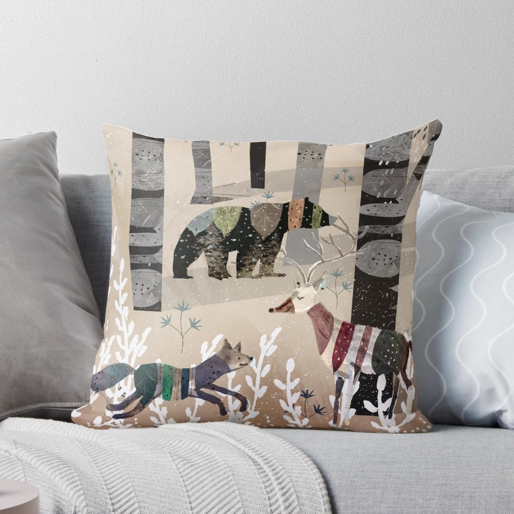 A decorative throw pillow featuring a whimsical watercolor design of forest animals like bears, deer, and foxes in a cozy, winter scene.