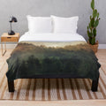 Plush blanket featuring a fairytale forest scene with trees, fog, and a dreamy, nostalgic atmosphere
