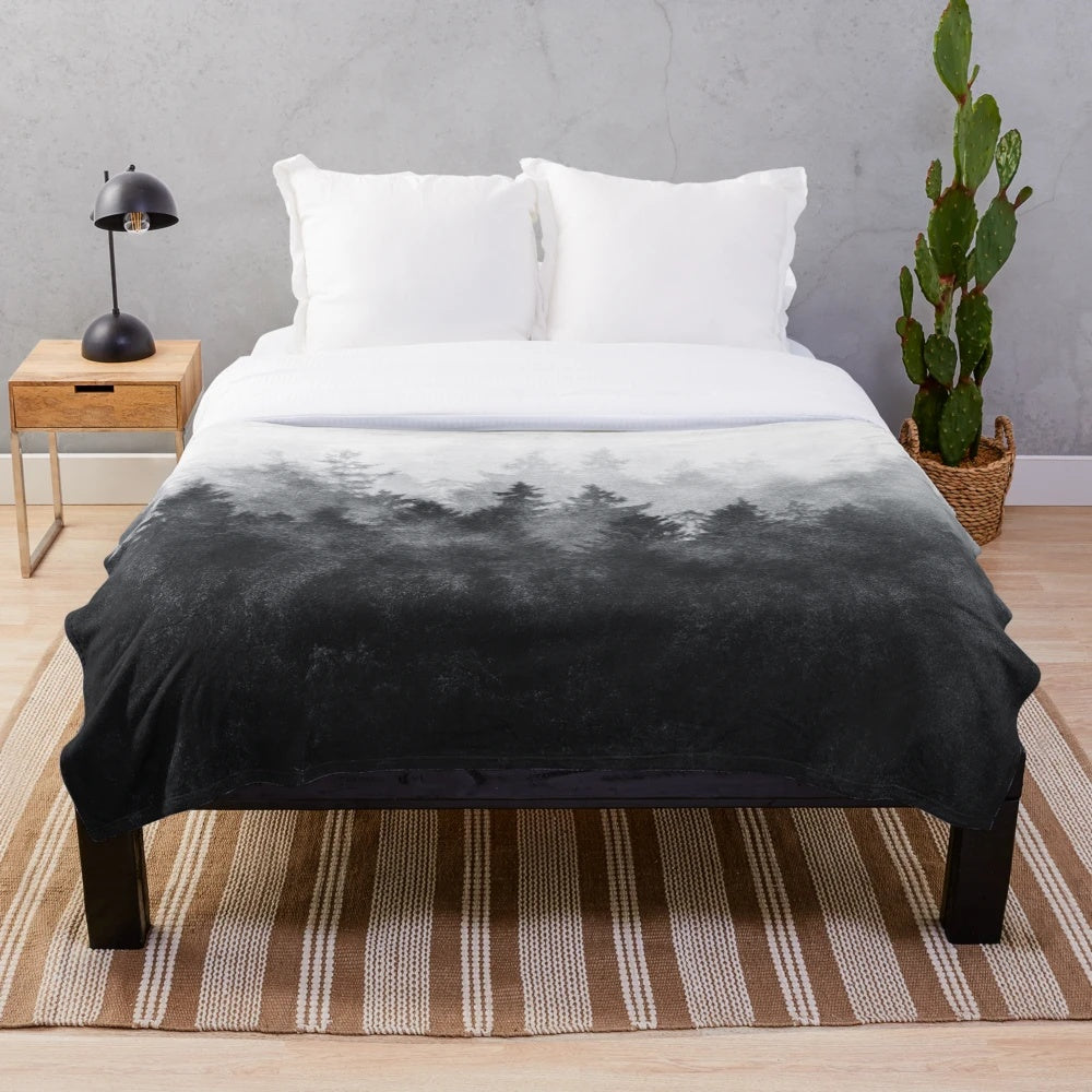 Plush blanket with a nature-inspired, gothic design featuring forests, trees, and fog