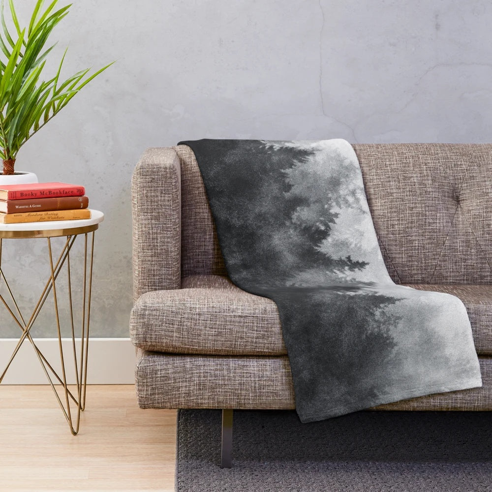 Plush blanket with a nature-inspired, gothic design featuring forests, trees, and fog