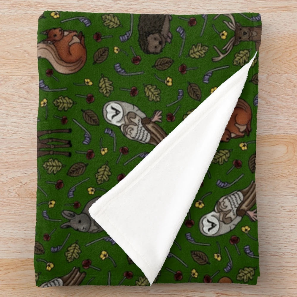 Forest-themed plush blanket featuring illustrations of British woodland animals like stag, fox, and red squirrel