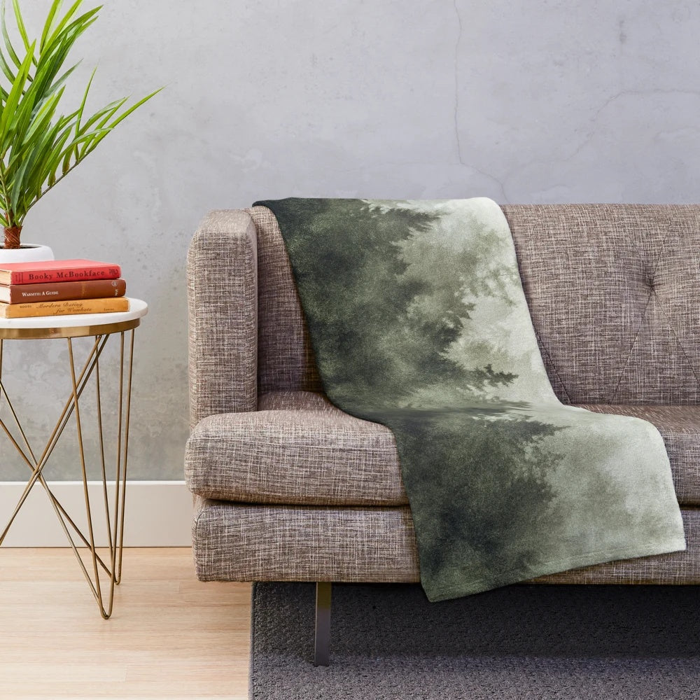 Plush blanket with a scenic forest landscape design