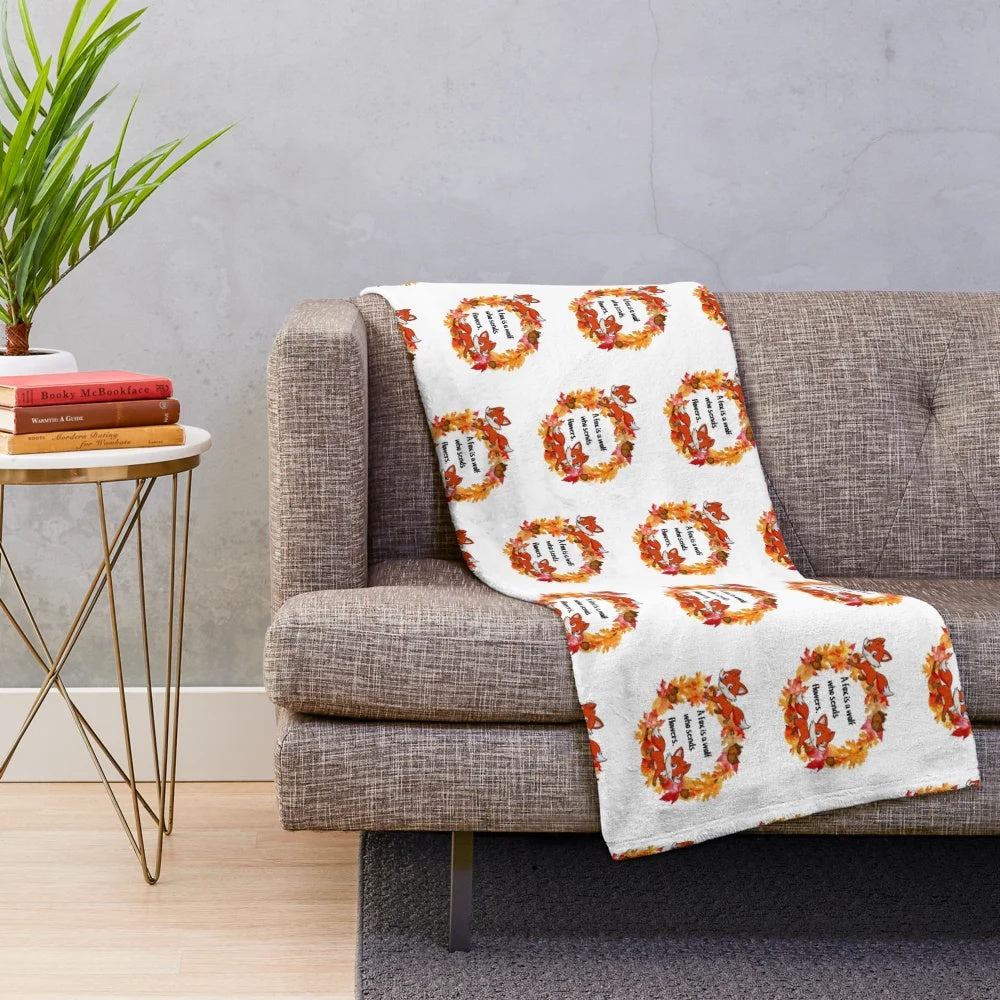 Plush blanket featuring a whimsical fox design in autumn colors