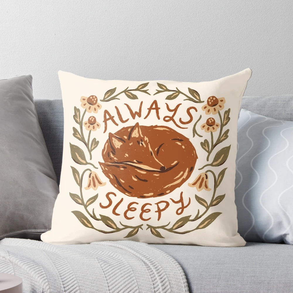 A cozy fox-themed decorative pillow with floral design and inspirational handlettering