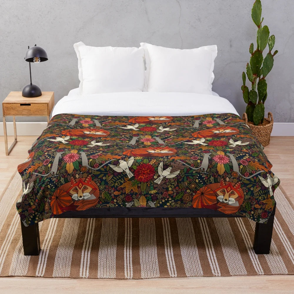 Plush blanket with a nature-inspired fox and floral pattern design