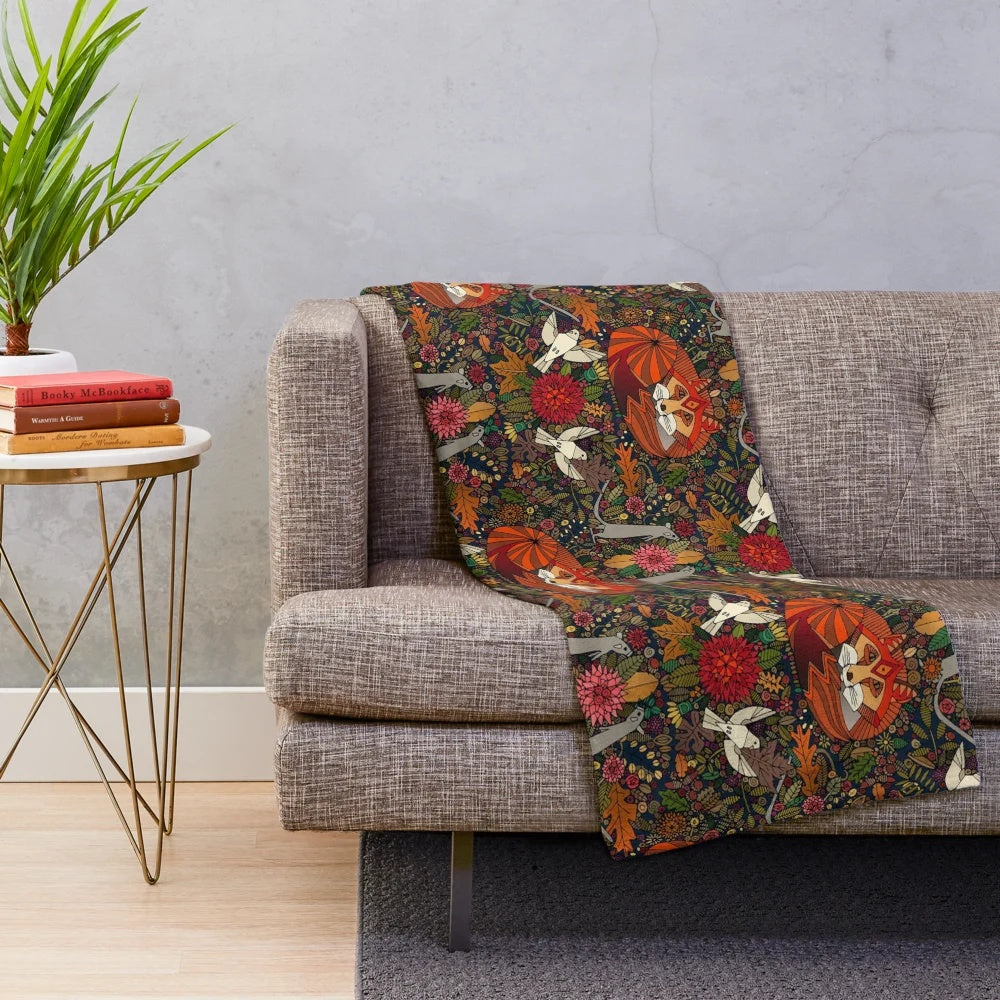 Plush blanket with a nature-inspired fox and floral pattern design