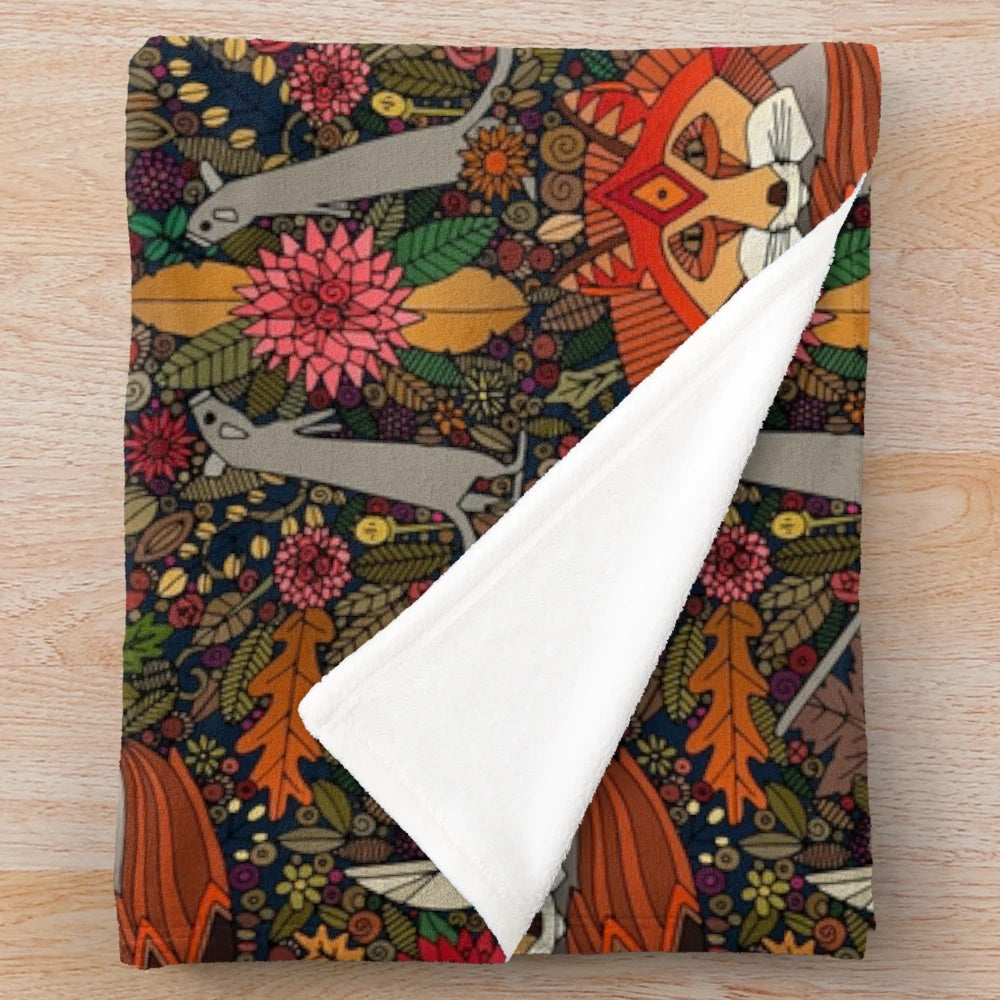 Plush blanket with a nature-inspired fox and floral pattern design