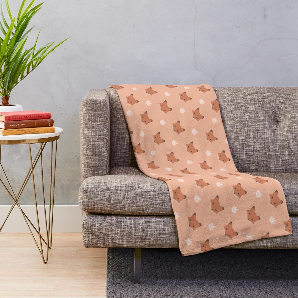 A soft and plush fox print blanket in warm neutral colors.