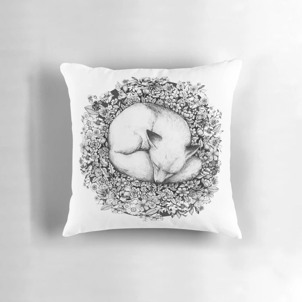 A black and white illustration of a fox sleeping peacefully among a field of flowers.
