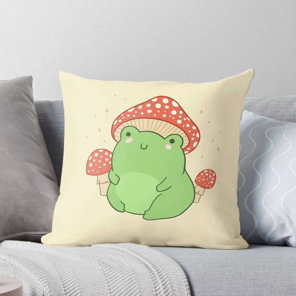 Soft, plush pillow featuring a cute, chubby frog wearing a whimsical mushroom hat, perfect for a cottagecore or forest-themed room decor.
