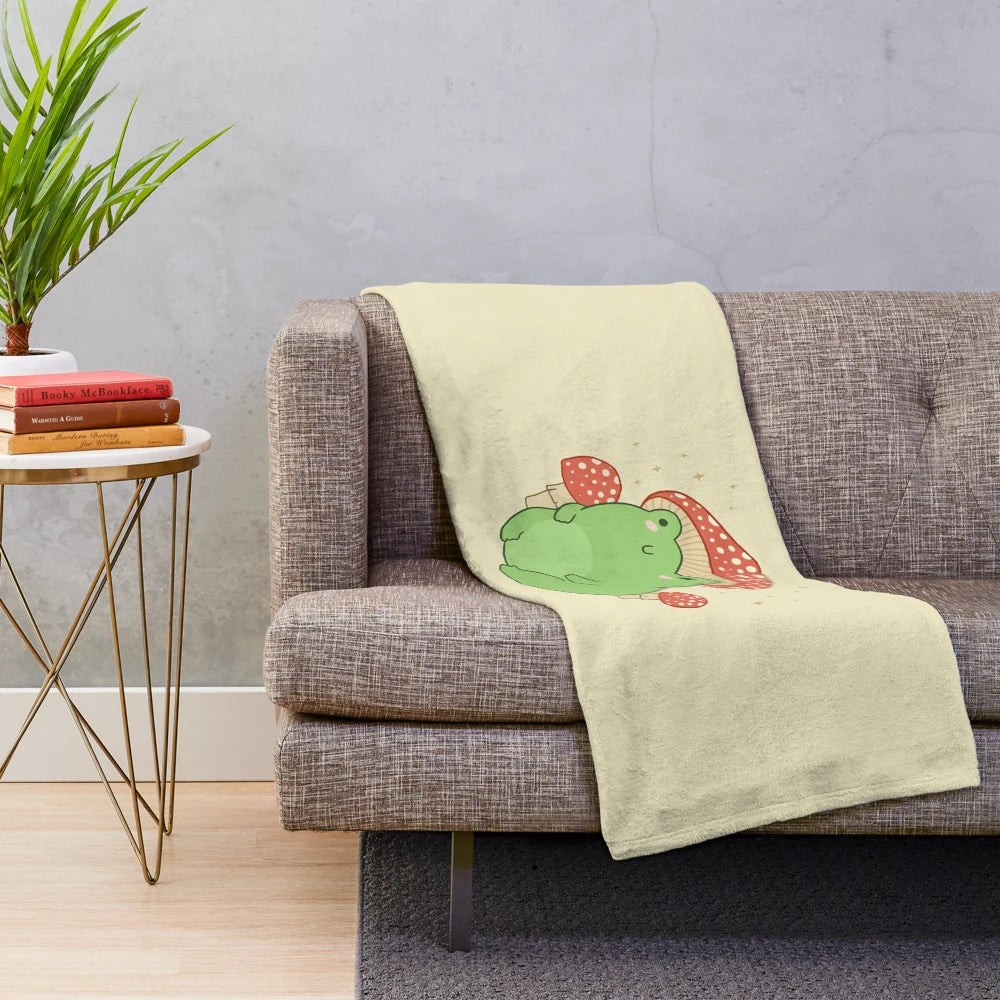 Cute frog plush with mushroom hat on a plush blanket