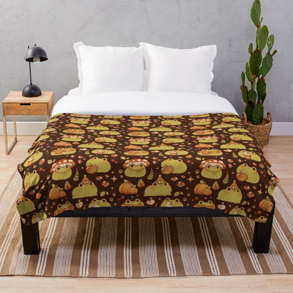 Plush blanket featuring a cute frog design, perfect for fall and Halloween