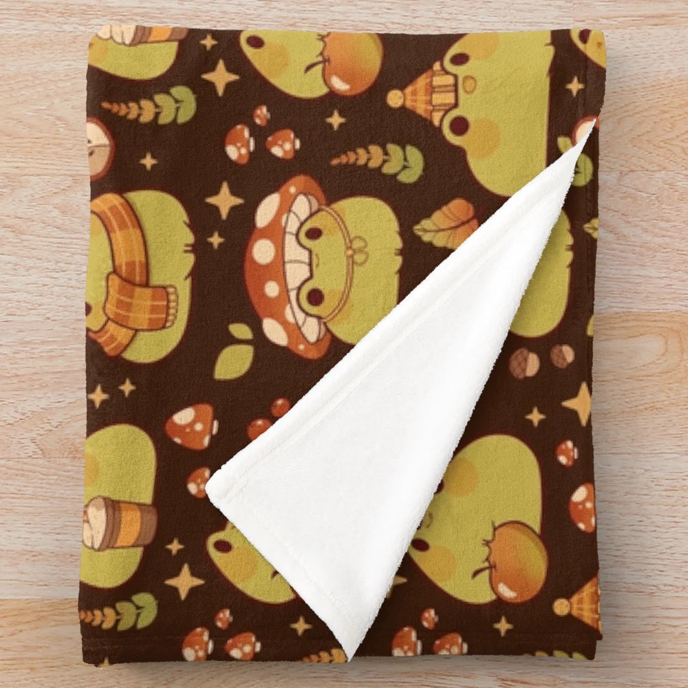 Plush blanket featuring a cute frog design, perfect for fall and Halloween