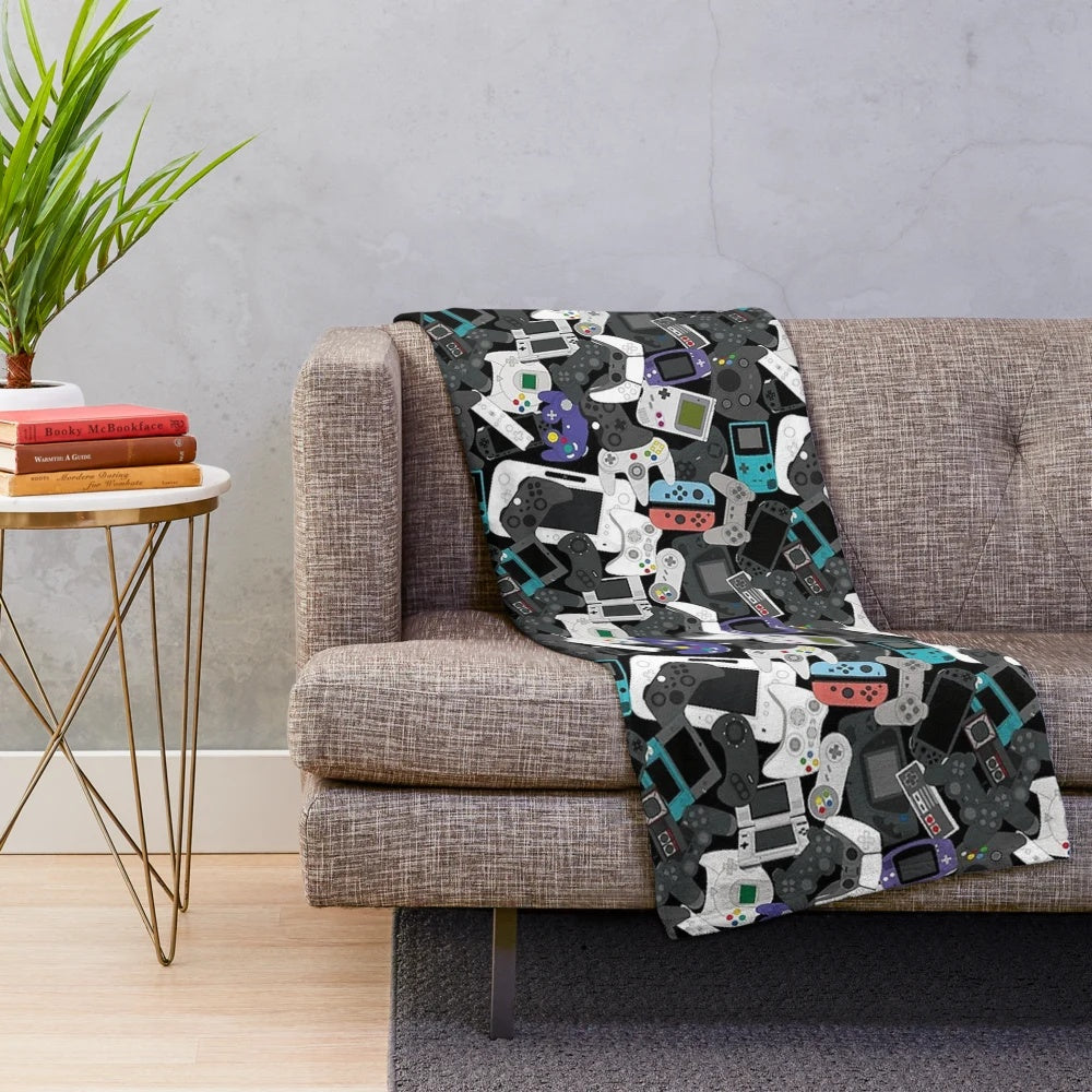 Plush gaming blanket featuring a retro game controller design