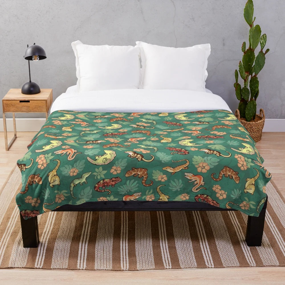 Vibrant green plush blanket featuring a family of geckos