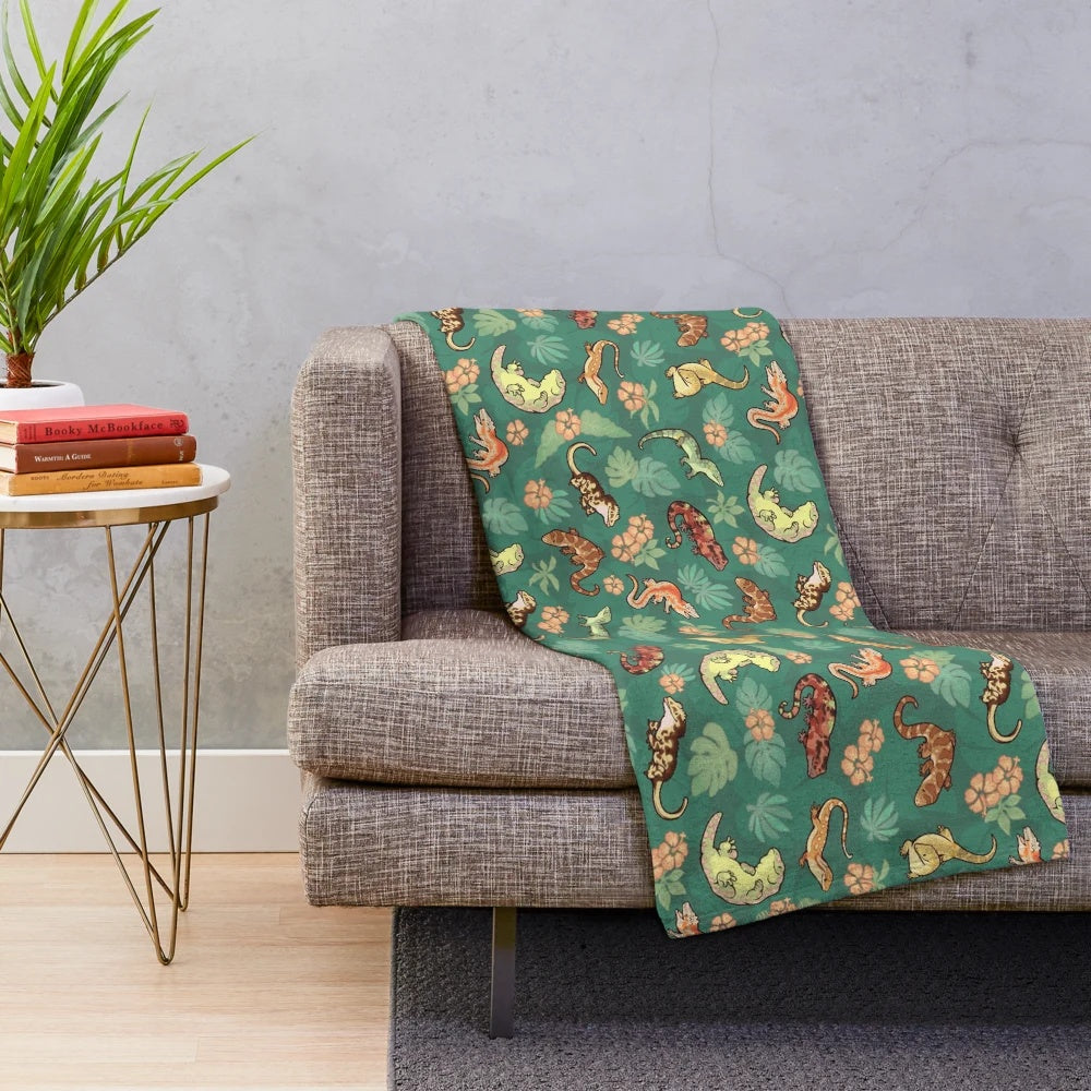 Vibrant green plush blanket featuring a family of geckos