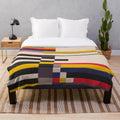 Geometric design inspired plush blanket with abstract patterns and color blocks