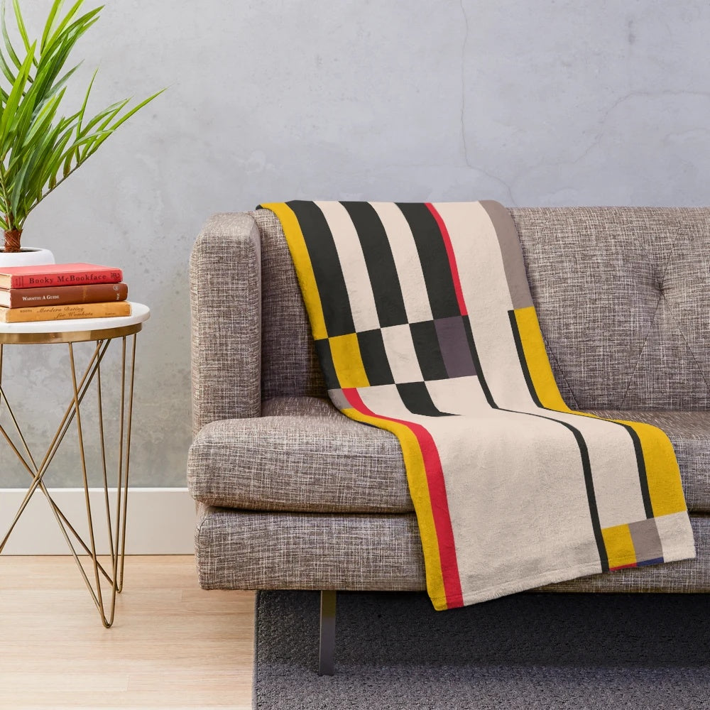 Geometric design inspired plush blanket with abstract patterns and color blocks