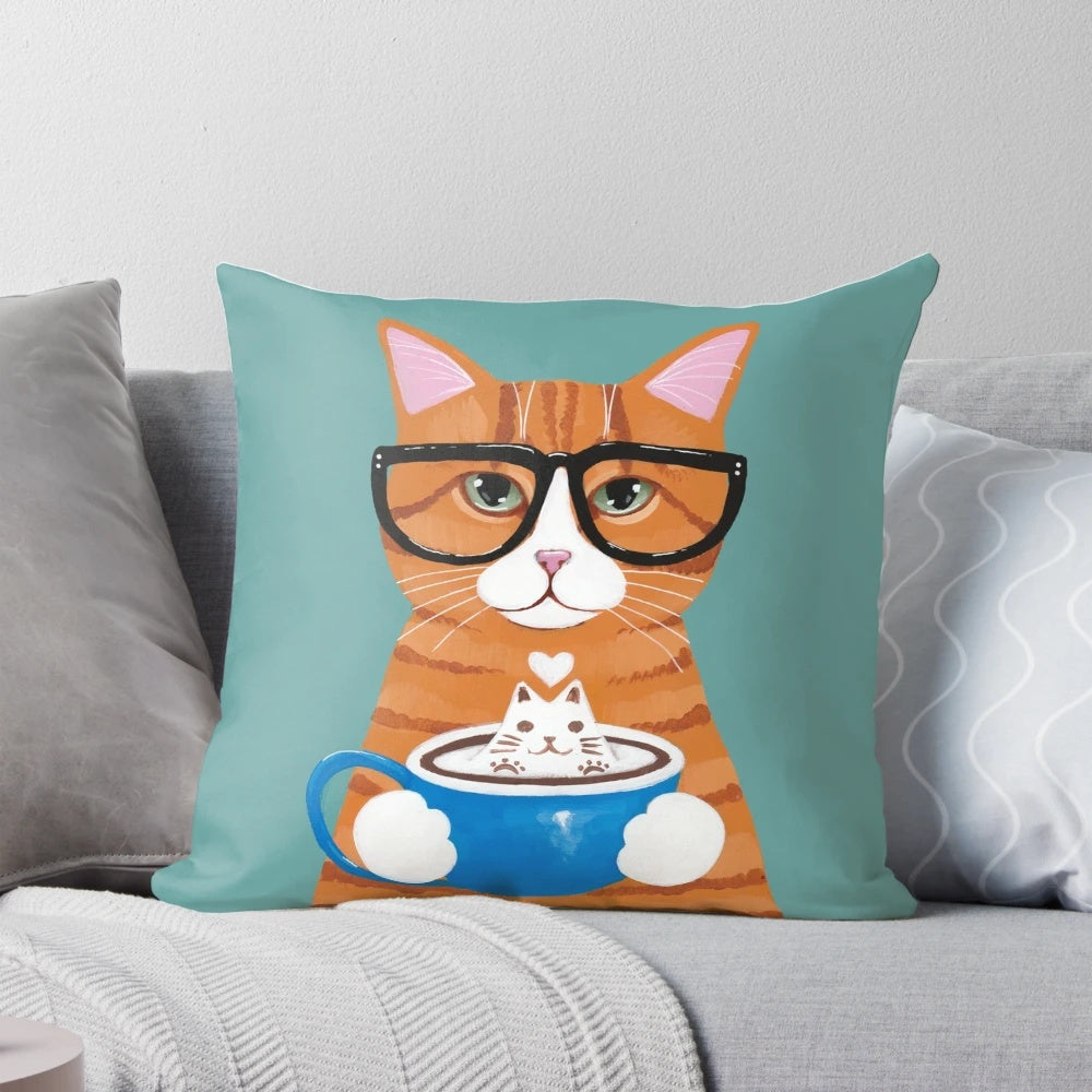 A charming ginger cat wearing glasses and sipping on a cappuccino, depicted on a decorative throw pillow.