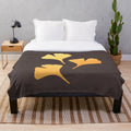 Ginkgo leaves plush blanket in shades of yellow, green, and brown