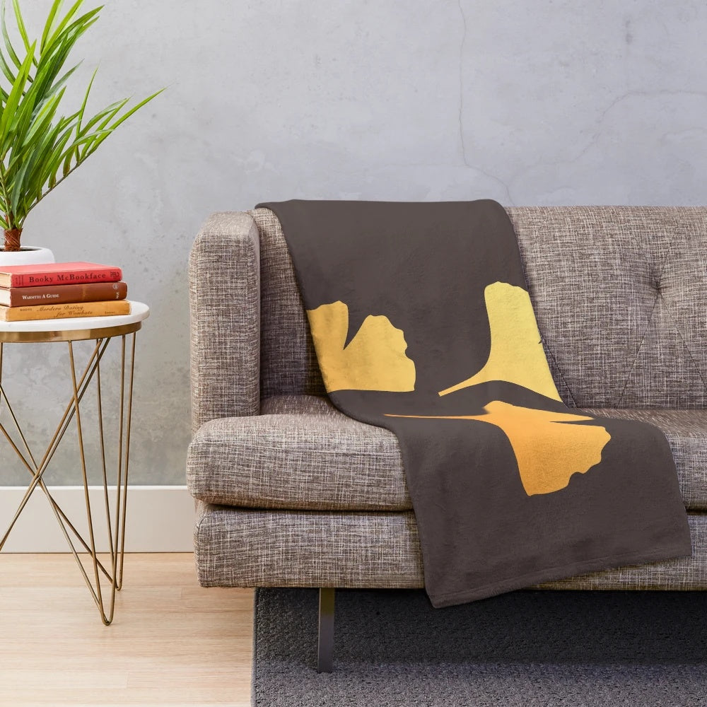 Ginkgo leaves plush blanket in shades of yellow, green, and brown