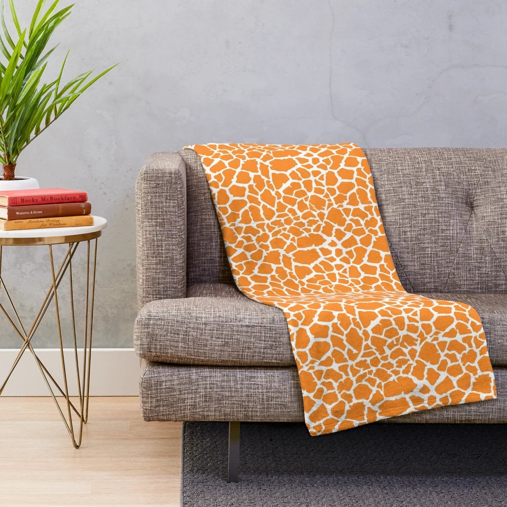 Giraffe plush blanket with soft, textured fabric
