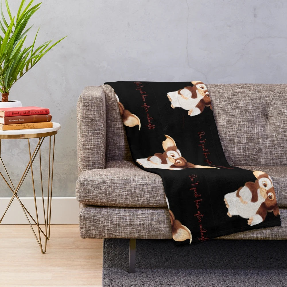 Gizmo-inspired plush blanket with a furry creature design