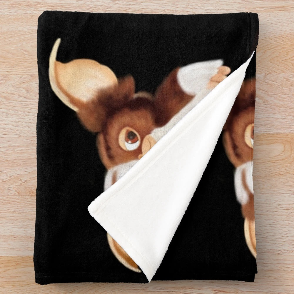 Gizmo-inspired plush blanket with a furry creature design